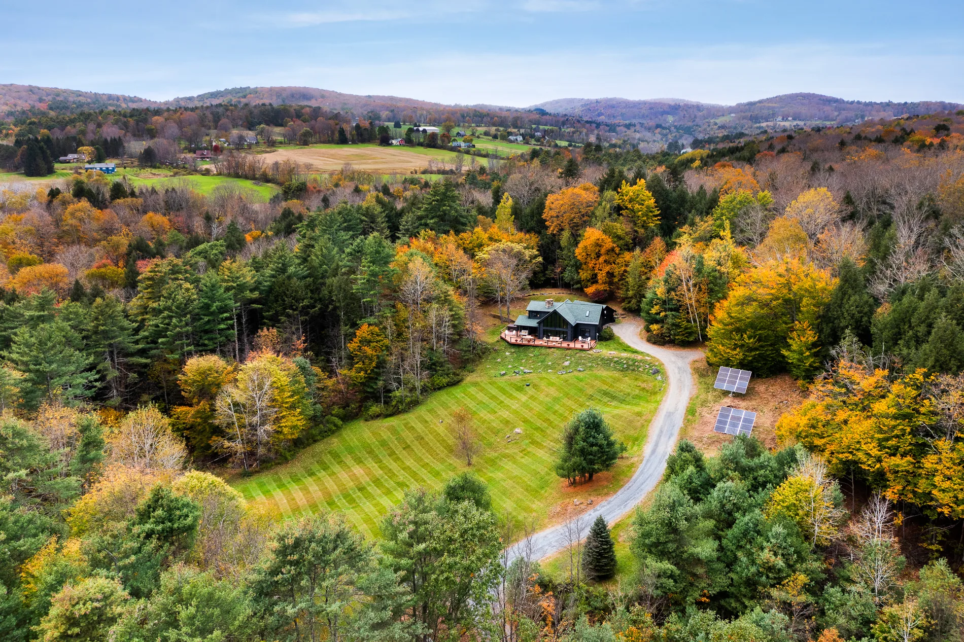 Aerial view of the Cozy Black Cabin surrounded by autumn foliage