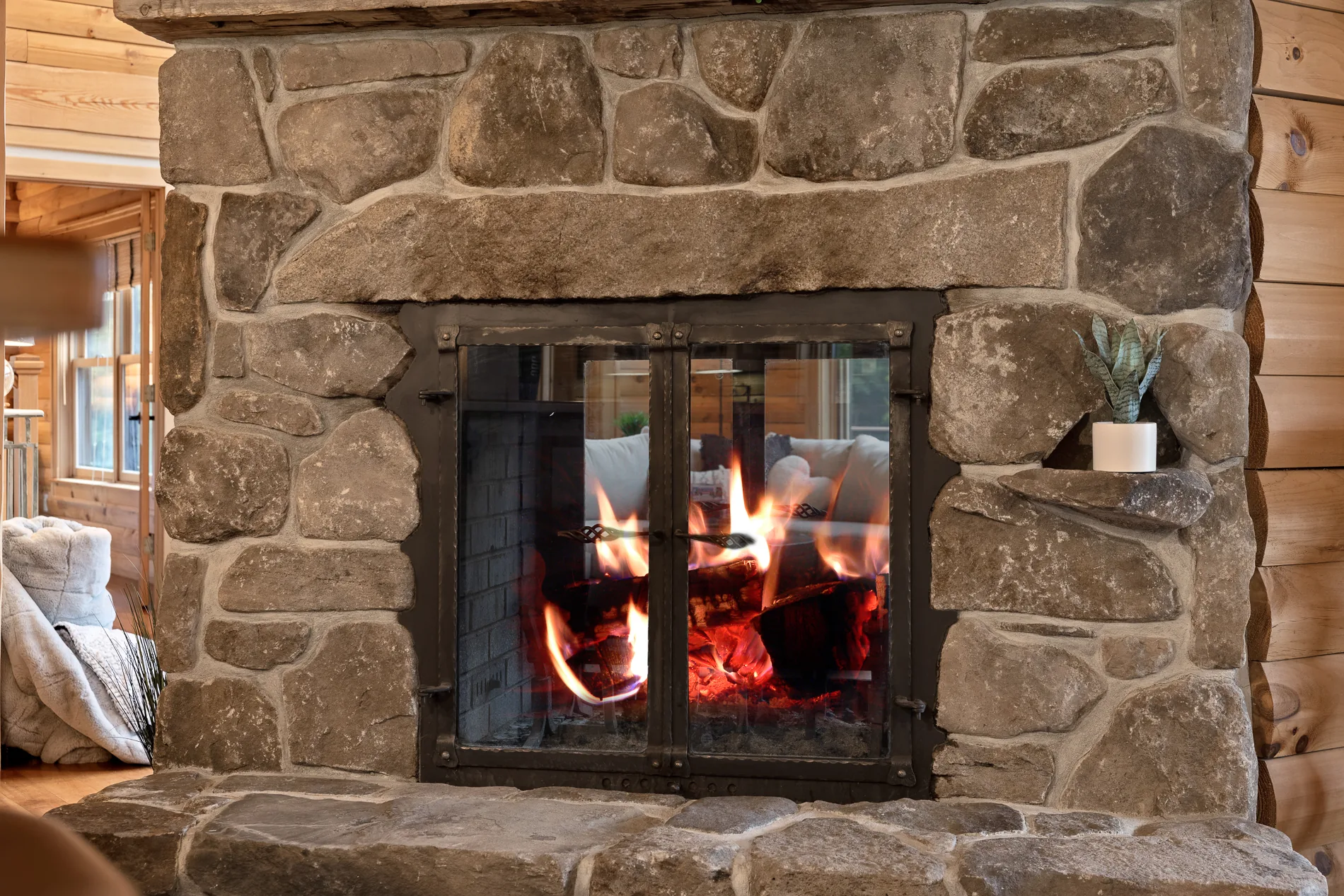 Stone fireplace with a fire burning